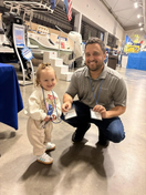 PartsDuck founder Nick Borrelli with his daughter at an indoor boat show.