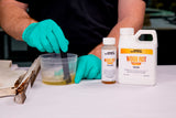 WEST SYSTEM manufacturer demonstration: mixing the 12 oz Wood Rot Repair kit beside damaged wood